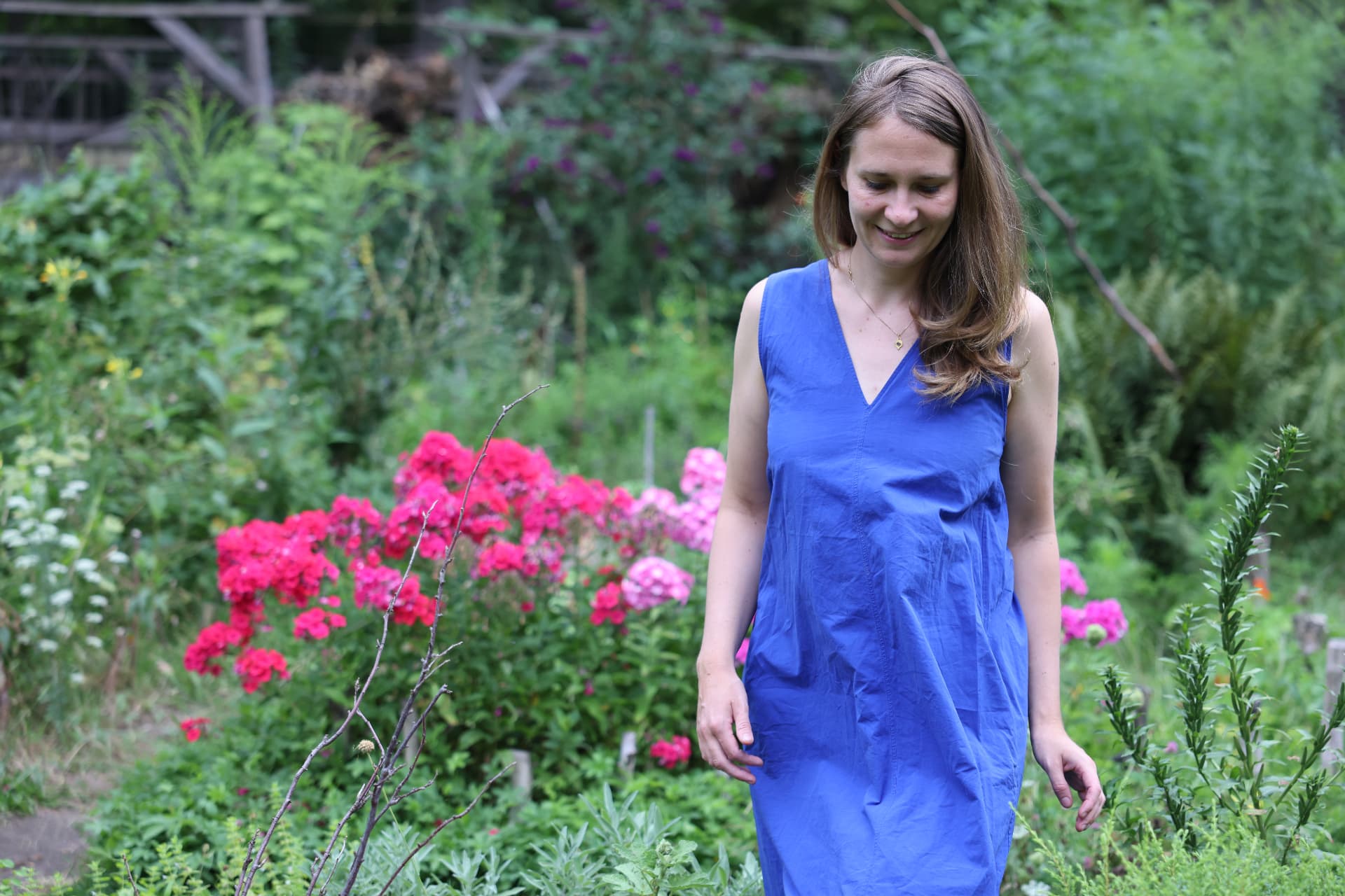 Marie standing peacefully in a blooming garden